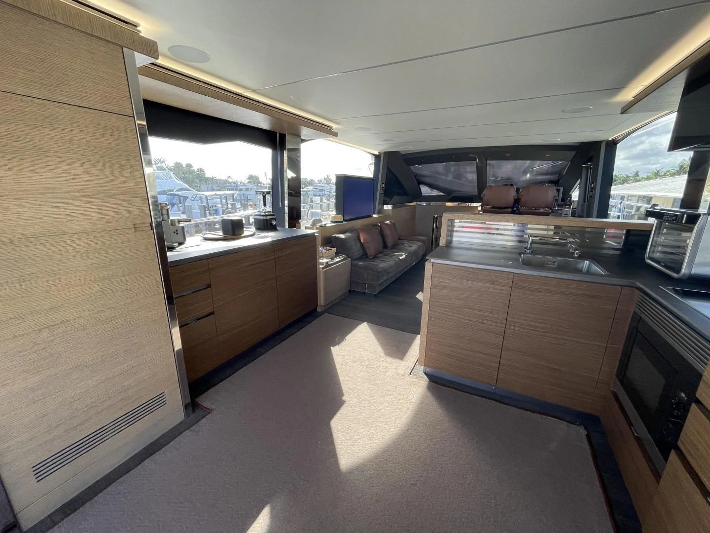 a kitchen with a couch and a tv aboard LEBRADA Yacht for Sale