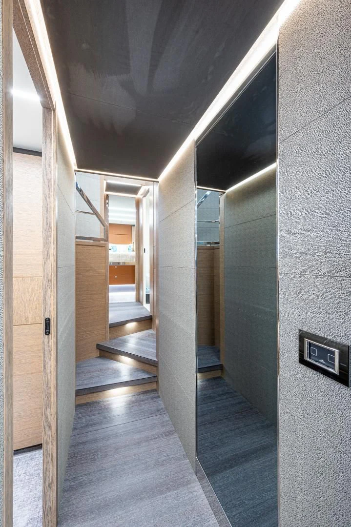 a hallway with a door and a railing aboard LEBRADA Yacht for Sale