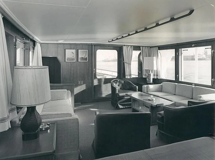 a living room with a couch and a table aboard TARTAR Yacht for Sale