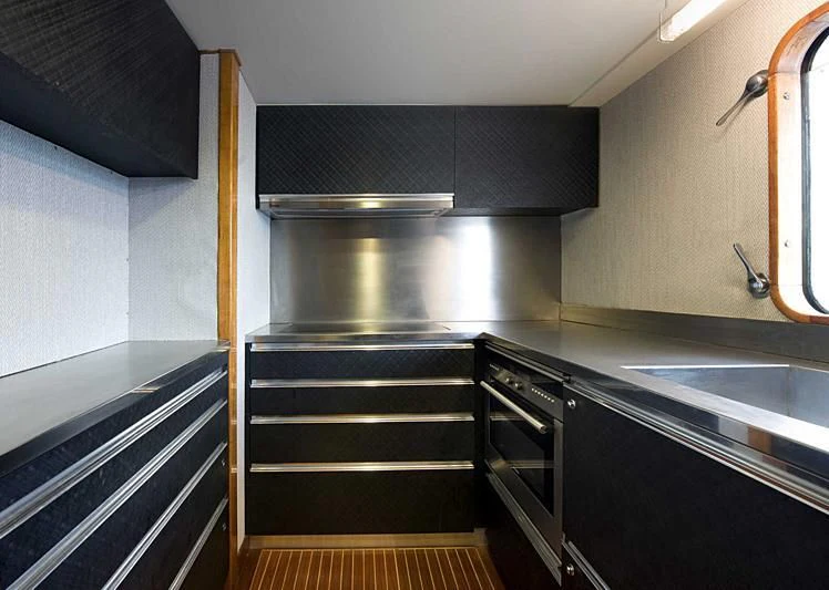 a kitchen with stainless steel appliances aboard TARTAR Yacht for Sale