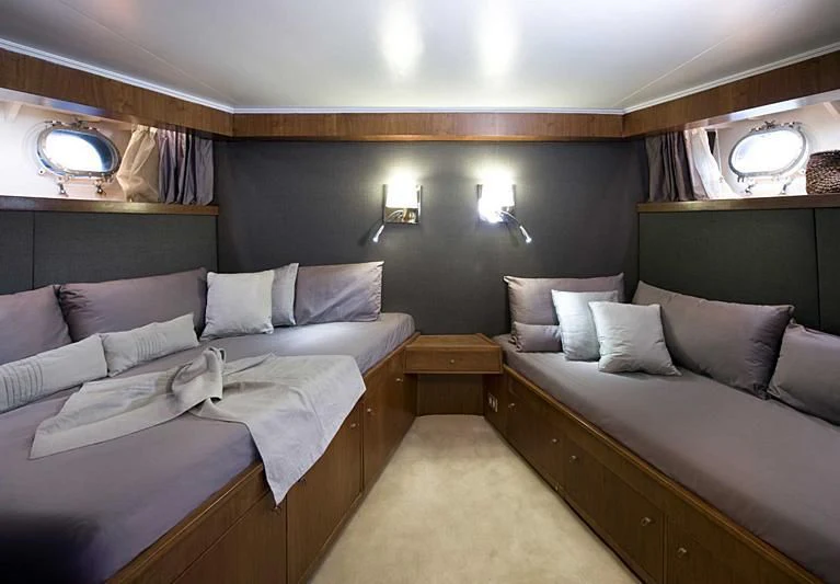 a room with a bed and a couch aboard TARTAR Yacht for Sale