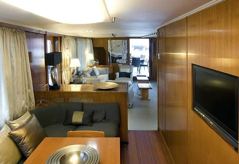 a living room with a tv and a couch aboard TARTAR Yacht for Sale