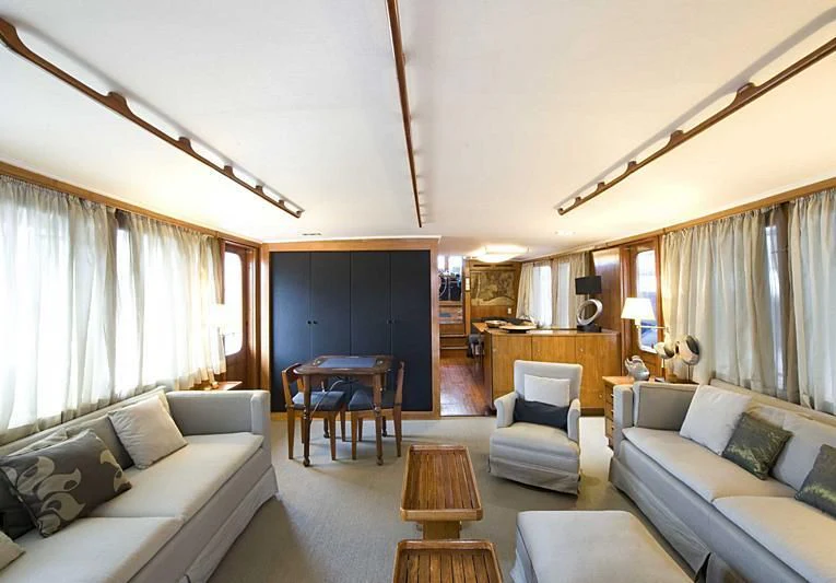 a living room with a couch and a table aboard TARTAR Yacht for Sale