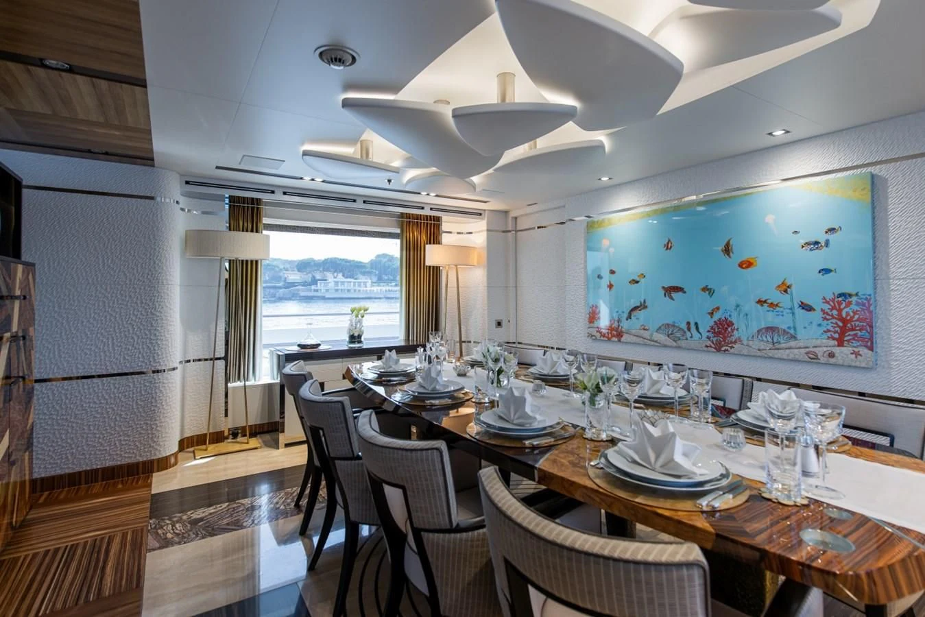 a dining room with a large window aboard PHILOSOPHY Yacht for Sale