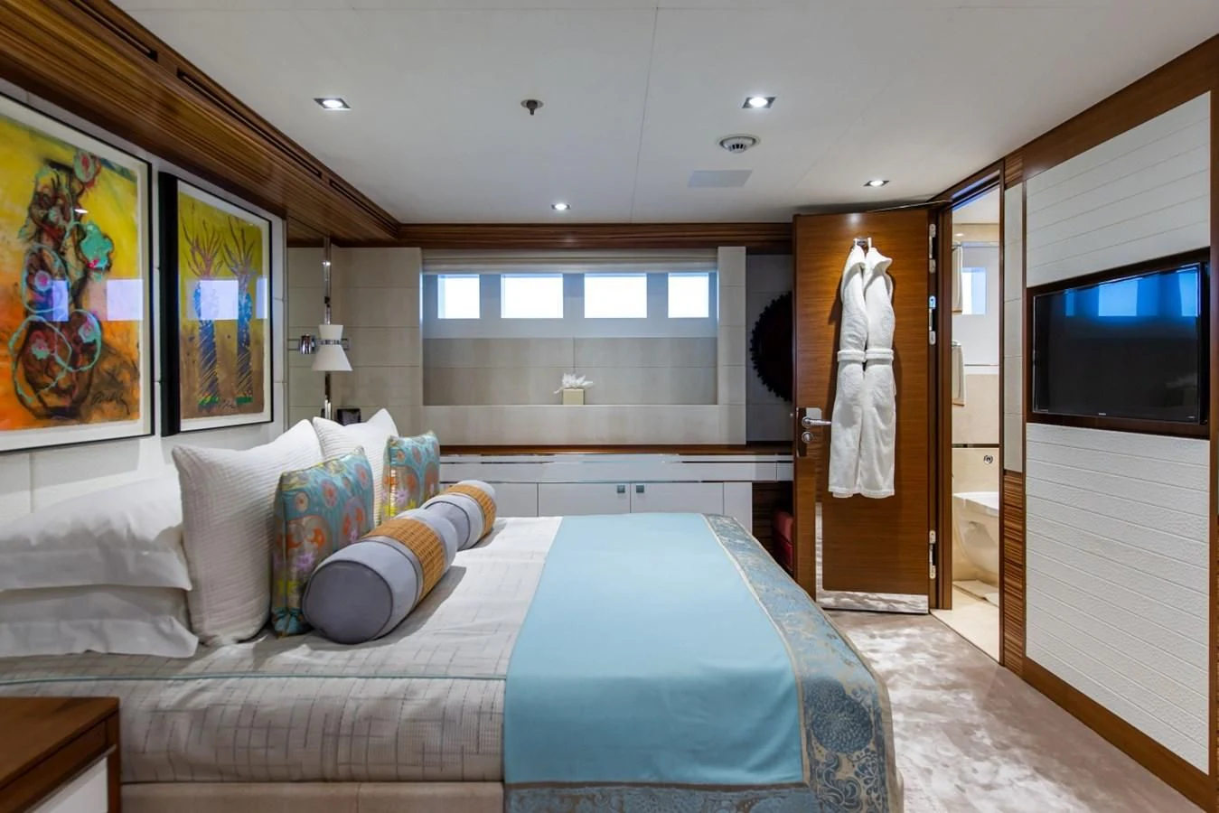 a bedroom with a bed and a television aboard PHILOSOPHY Yacht for Sale
