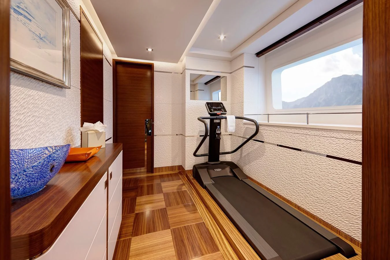 a room with a large window and a table with a camera on it aboard PHILOSOPHY Yacht for Sale