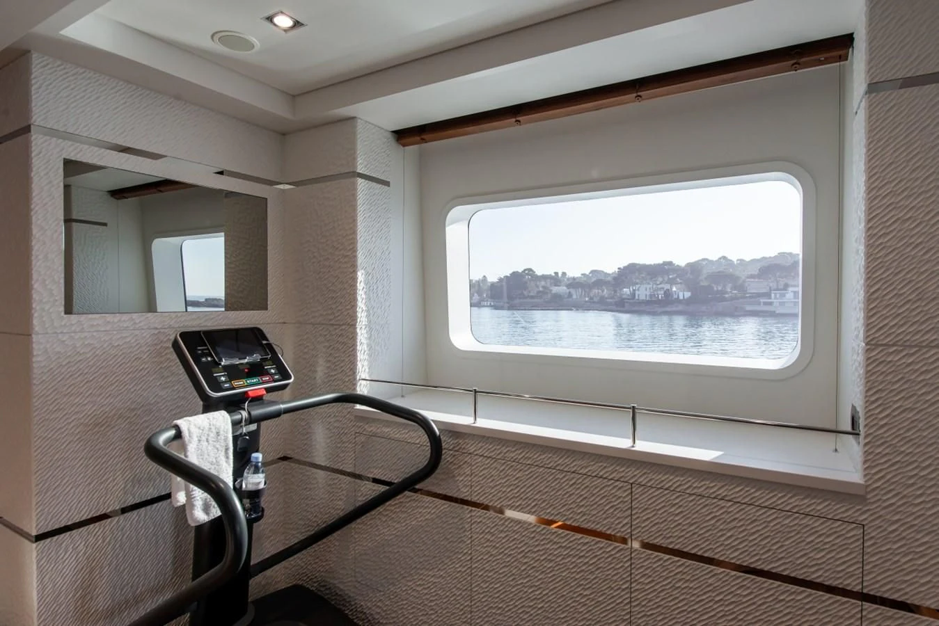 a room with a window and a laptop on a stand aboard PHILOSOPHY Yacht for Sale