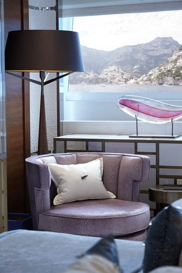 a chair next to a window aboard PHILOSOPHY Yacht for Sale