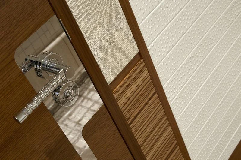 a wooden staircase with a metal railing aboard PHILOSOPHY Yacht for Sale