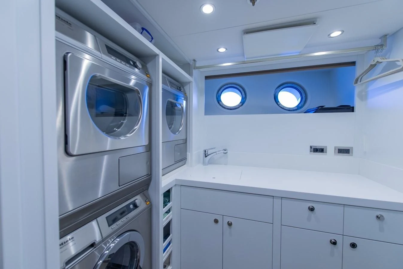 a white laundry room with a washing machine and washer aboard PHILOSOPHY Yacht for Sale