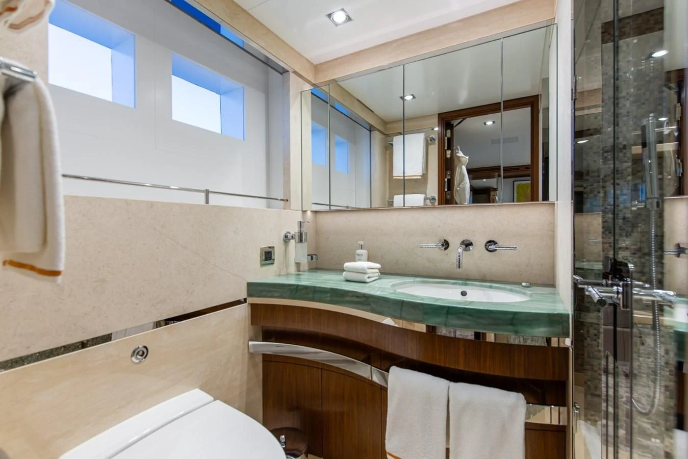 a bathroom with a large mirror aboard PHILOSOPHY Yacht for Sale
