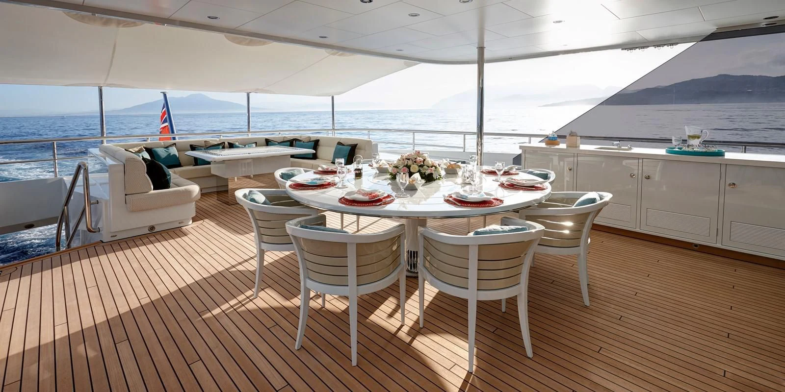 a table set for a meal on a deck aboard PHILOSOPHY Yacht for Sale