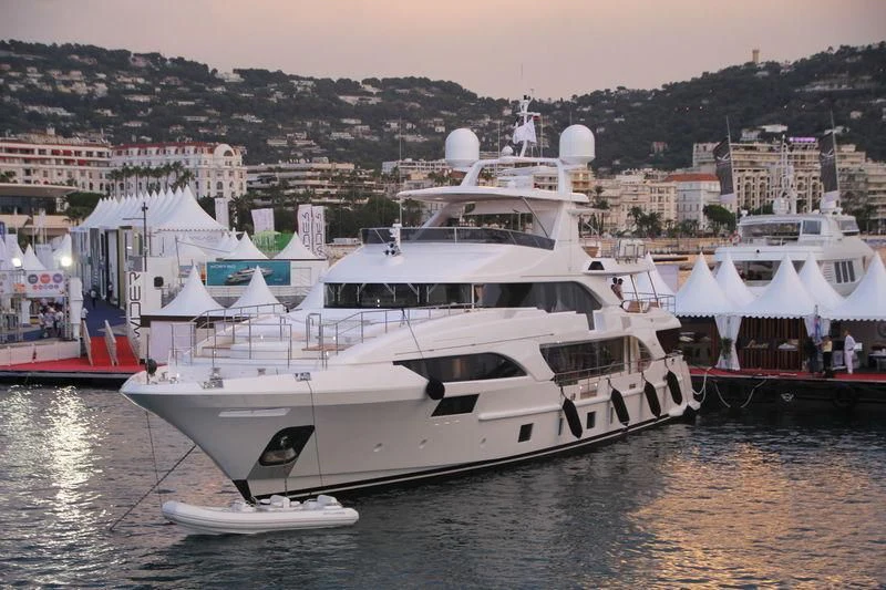 a large white boat sits in a harbor aboard ASIA POSEIDON Yacht for Sale