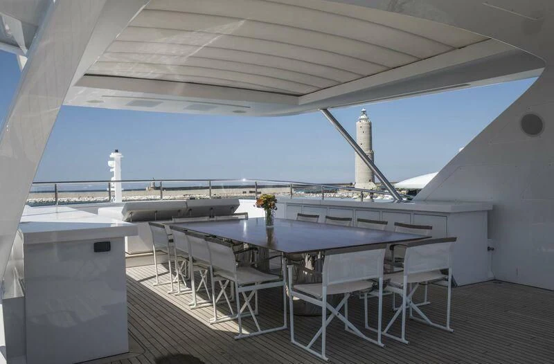 a table and chairs on a deck aboard ASIA POSEIDON Yacht for Sale