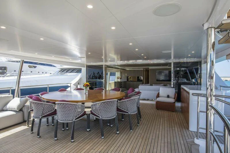 a large room with a table and chairs aboard ASIA POSEIDON Yacht for Sale