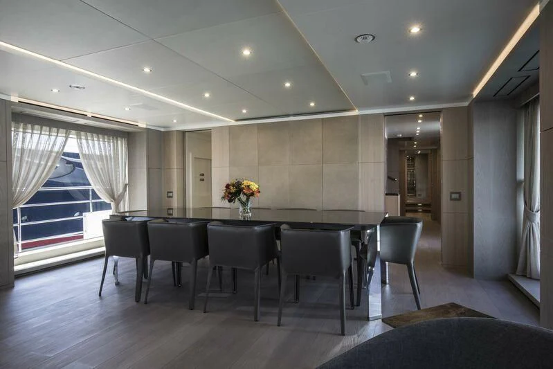 a large room with a table and chairs aboard ASIA POSEIDON Yacht for Sale