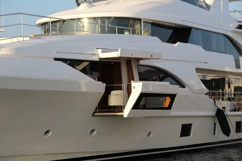 a white yacht with a balcony aboard ASIA POSEIDON Yacht for Sale