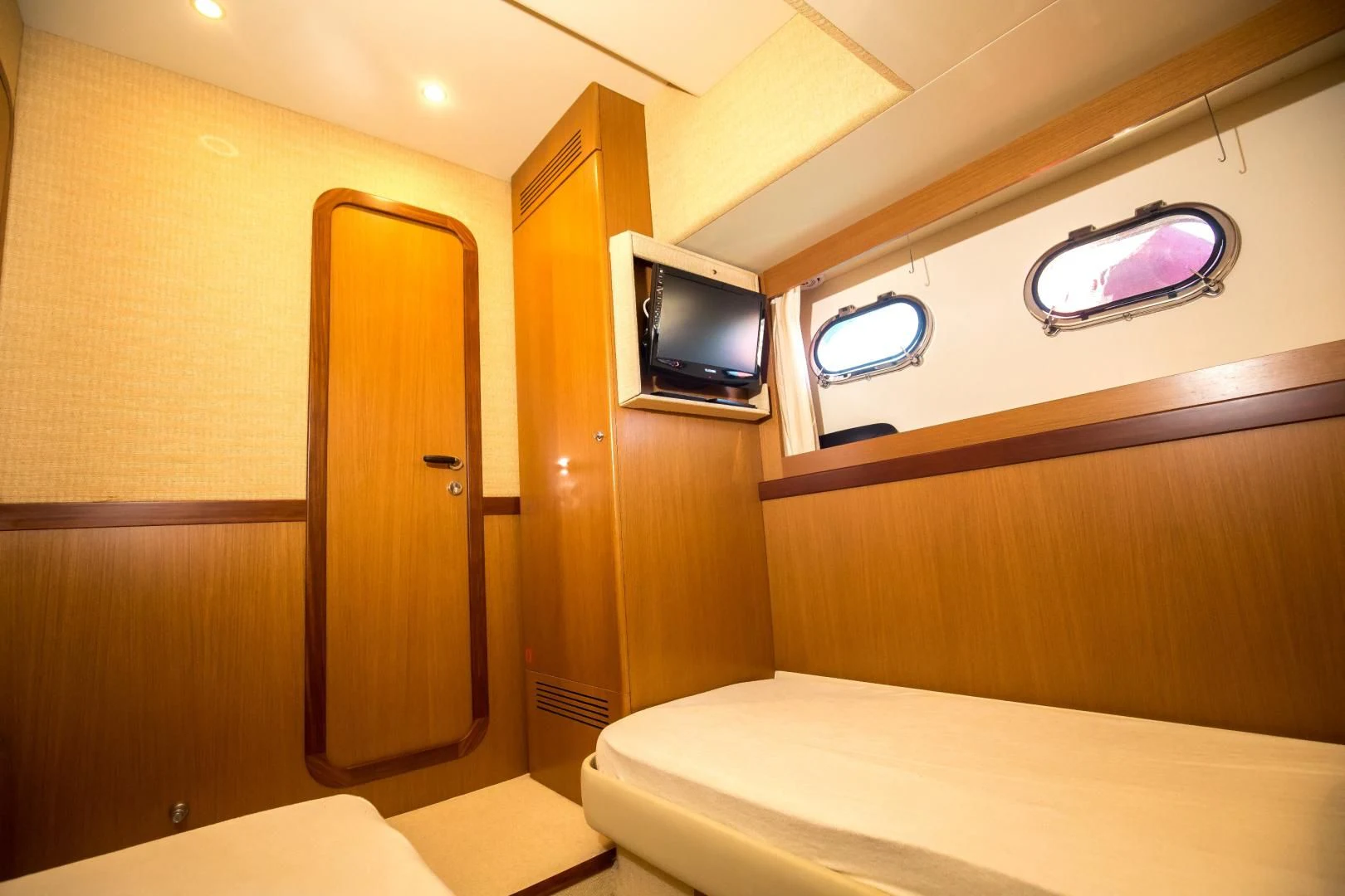 a room with a bed and a television aboard TESA Yacht for Sale