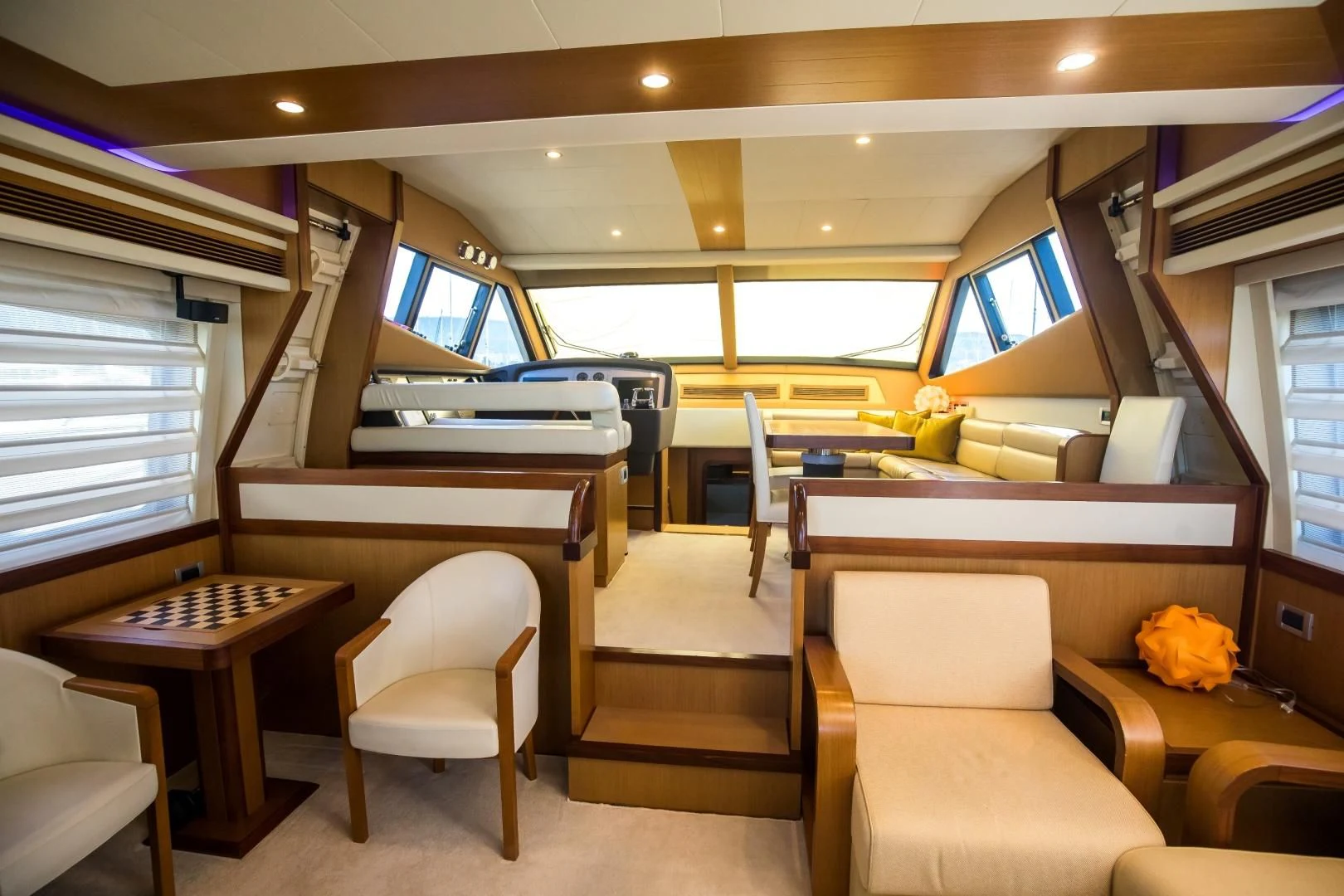a room with a desk and chairs aboard TESA Yacht for Sale