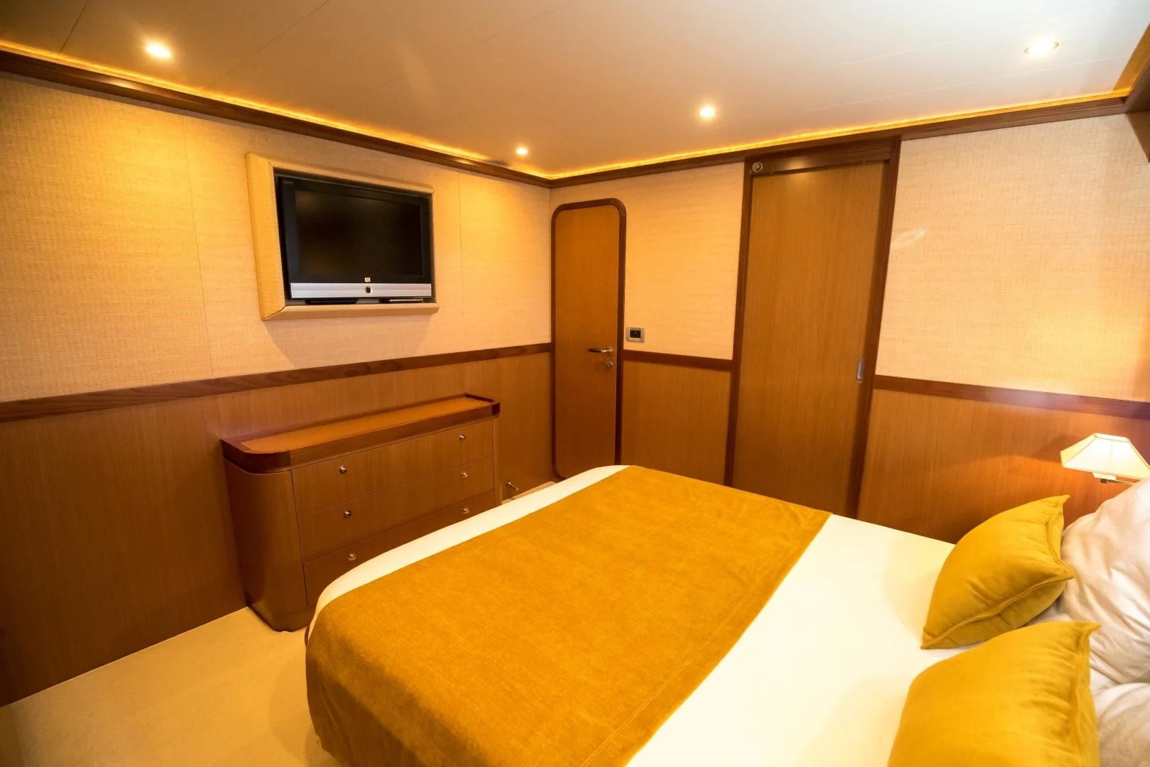 a hotel room with a bed and tv aboard TESA Yacht for Sale