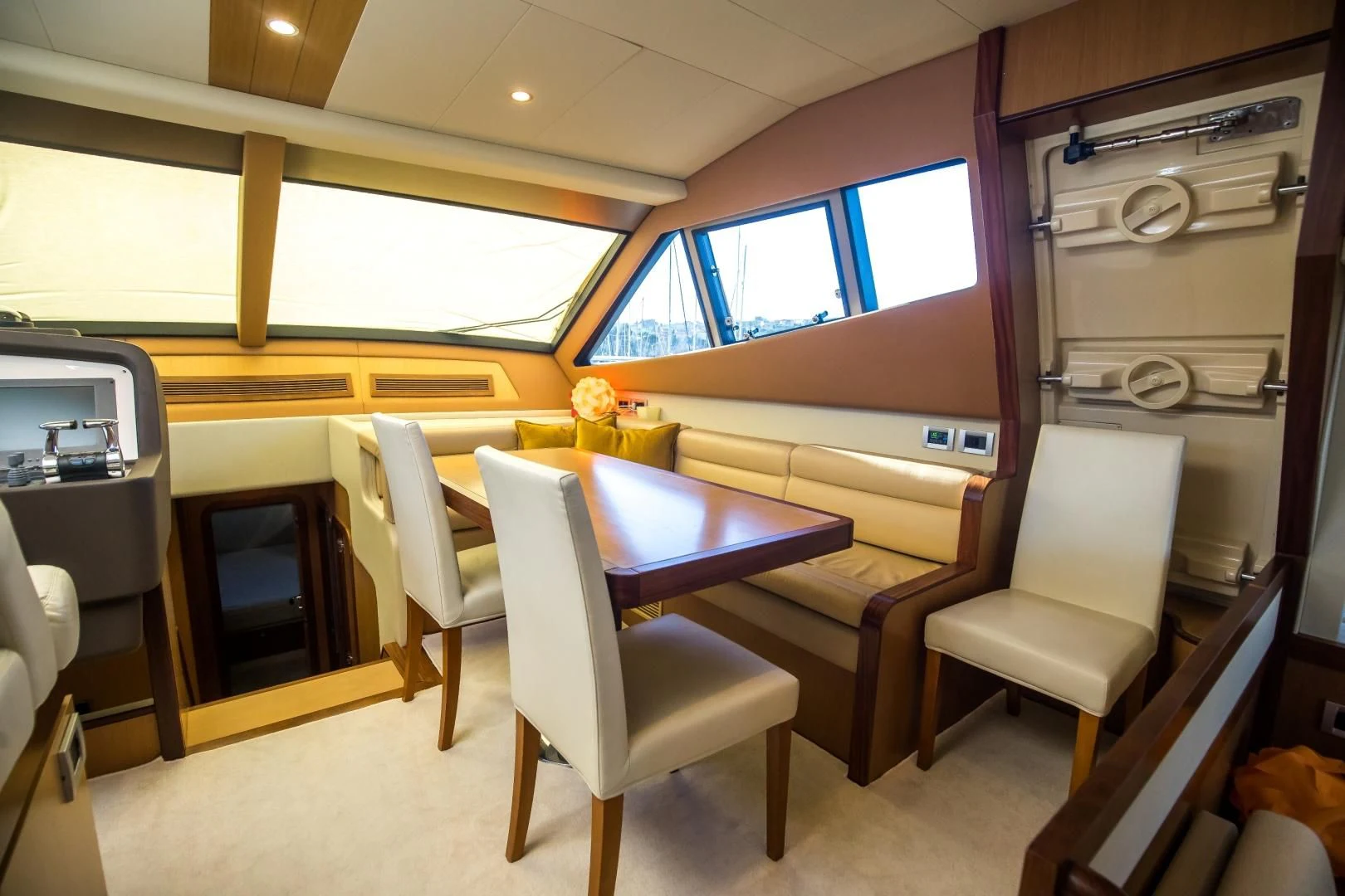 a room with a table and chairs aboard TESA Yacht for Sale