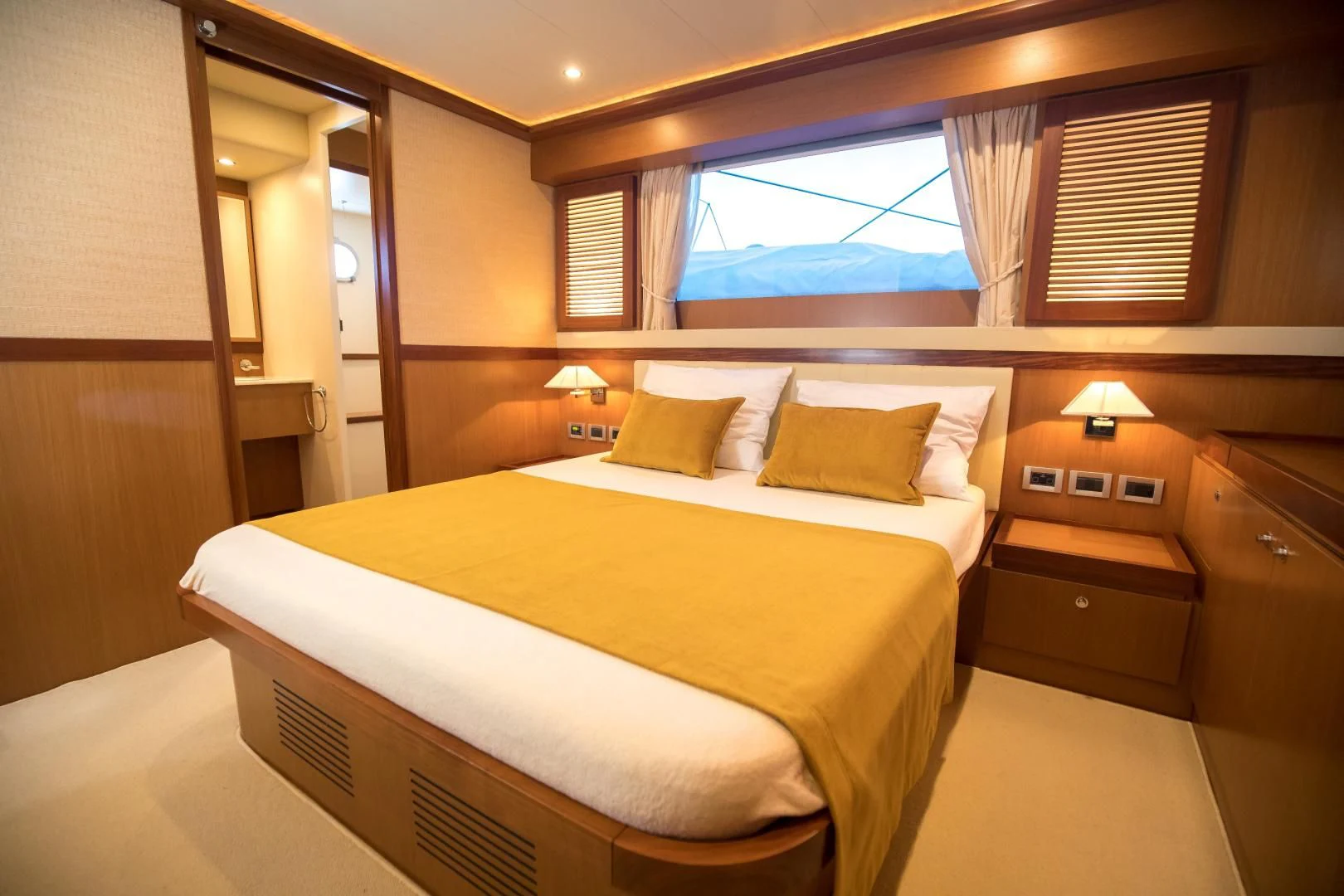 a room with a bed and a window aboard TESA Yacht for Sale