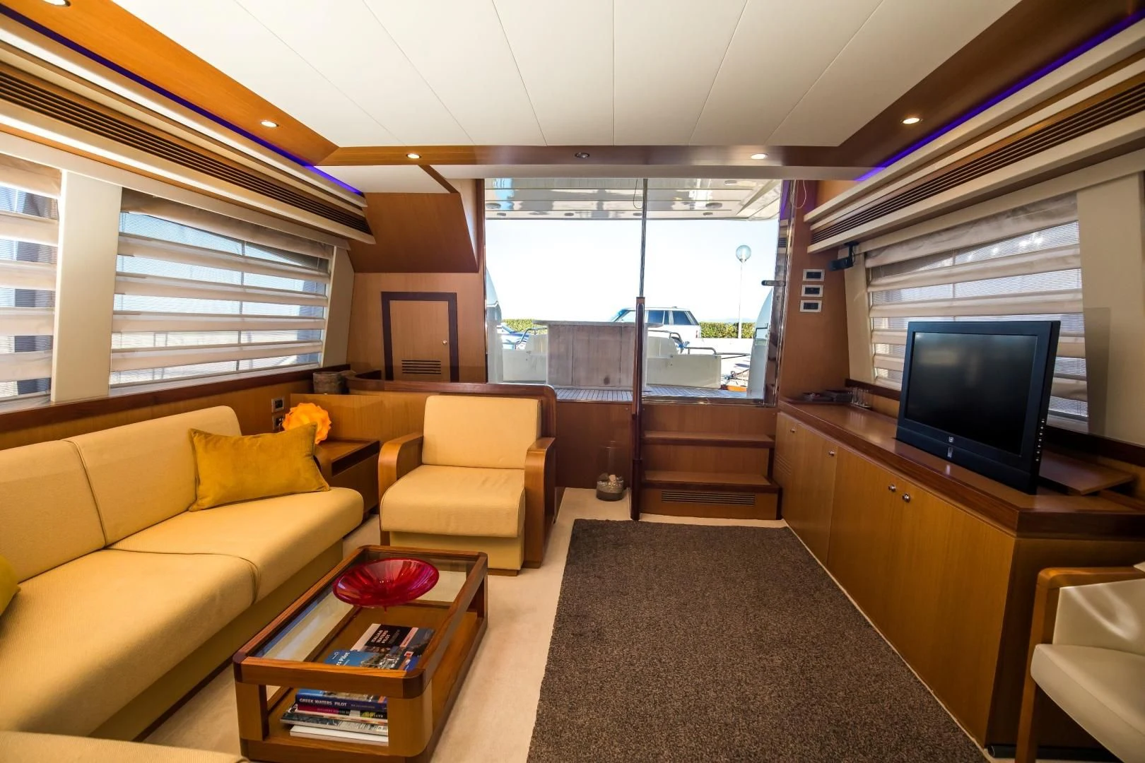 a living room with a tv and couches aboard TESA Yacht for Sale