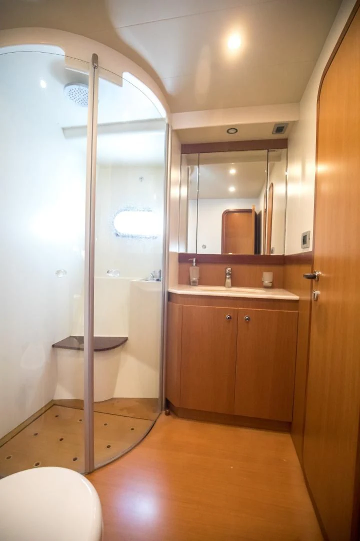 a bathroom with a glass shower aboard TESA Yacht for Sale