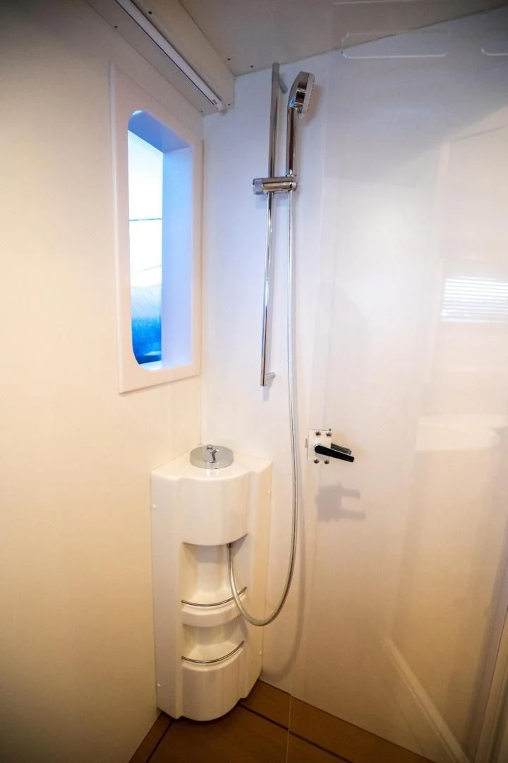 a bathroom with a toilet and a window aboard TESA Yacht for Sale