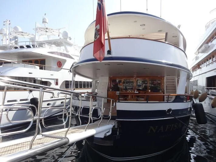 a boat docked at a pier aboard NAFISA Yacht for Sale