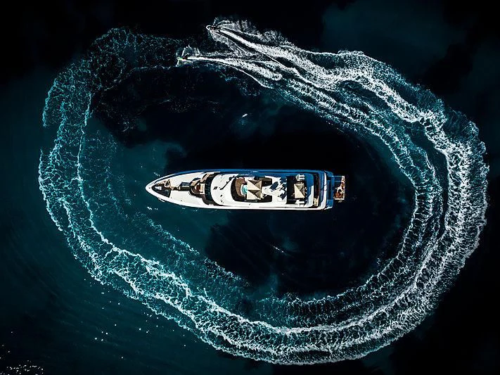 a planet with a black and white logo and a black background aboard DIANE Yacht for Charter