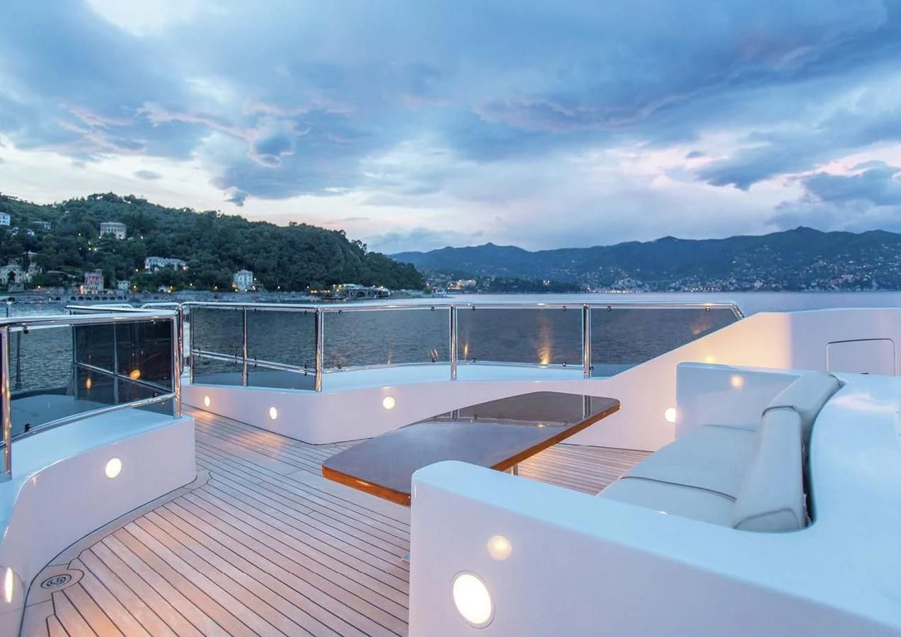 a deck with a view of the water and mountains in the background aboard DIANE Yacht for Charter