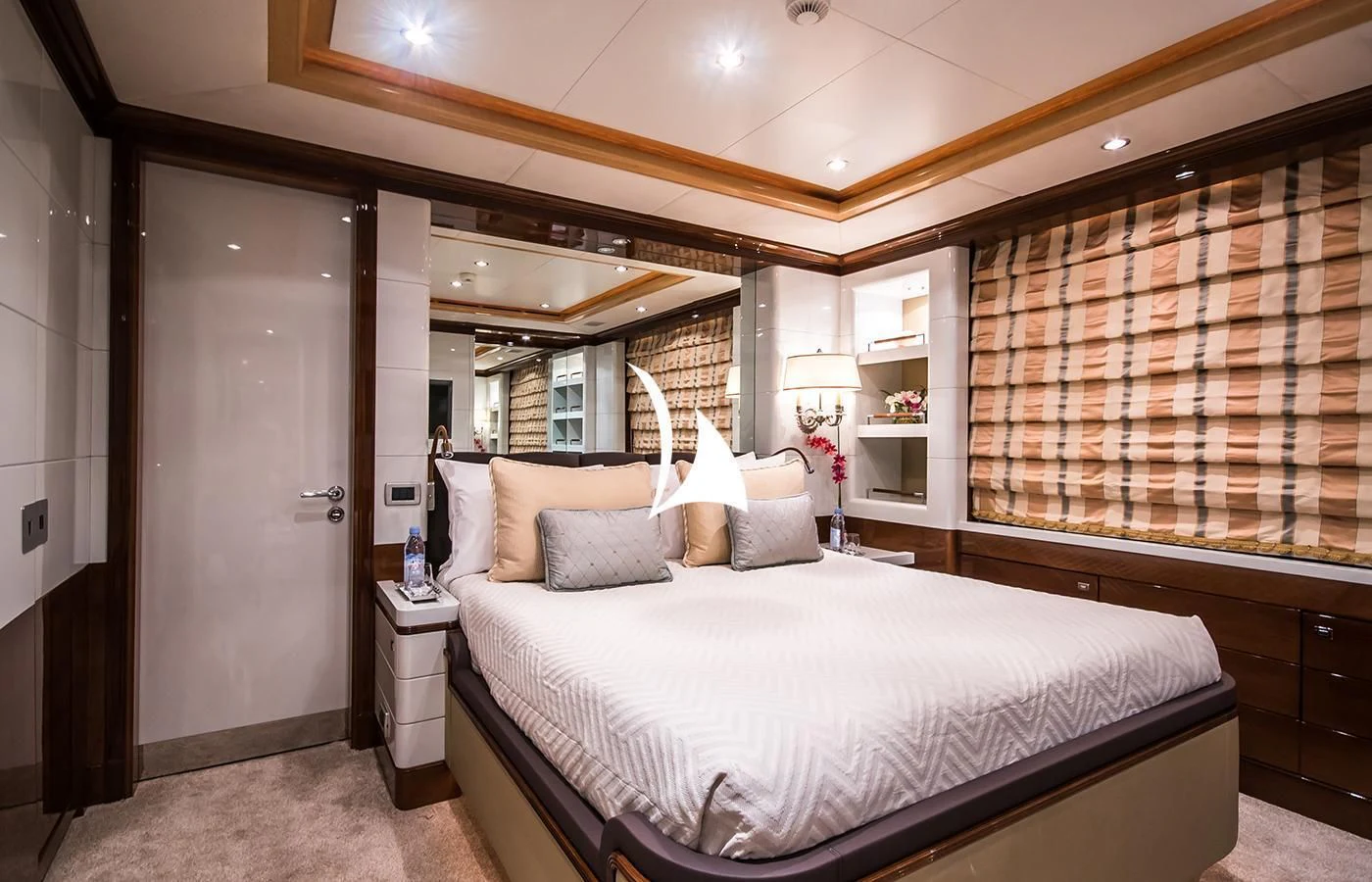 a bedroom with a bed and a mirror aboard DIANE Yacht for Charter