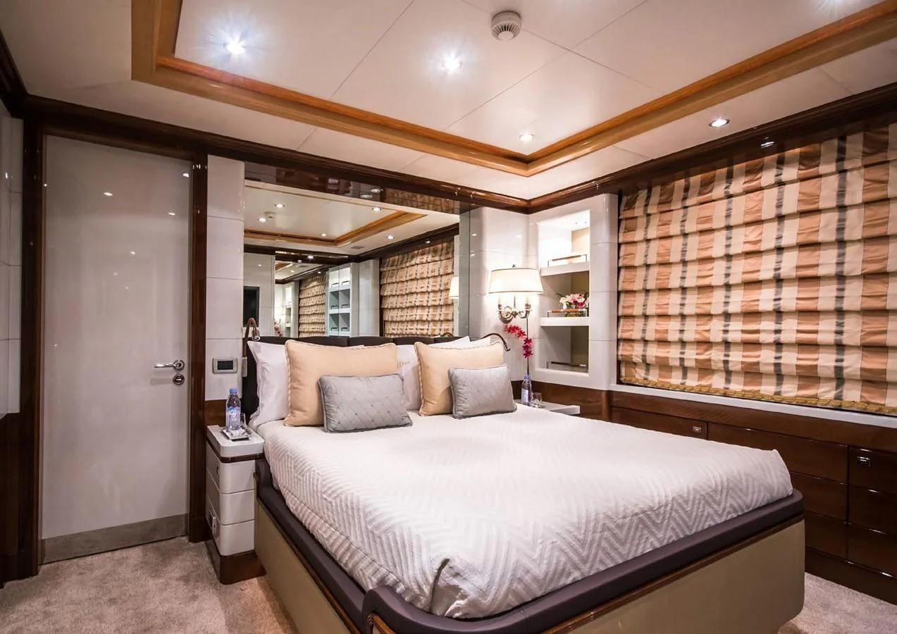 a bedroom with a bed and a mirror aboard DIANE Yacht for Charter