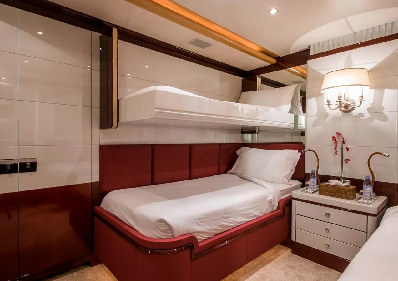 a room with a bed and a sink aboard DIANE Yacht for Charter