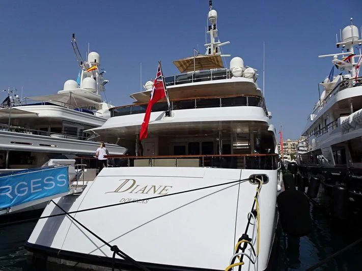 a large white boat with a flag on it aboard DIANE Yacht for Charter