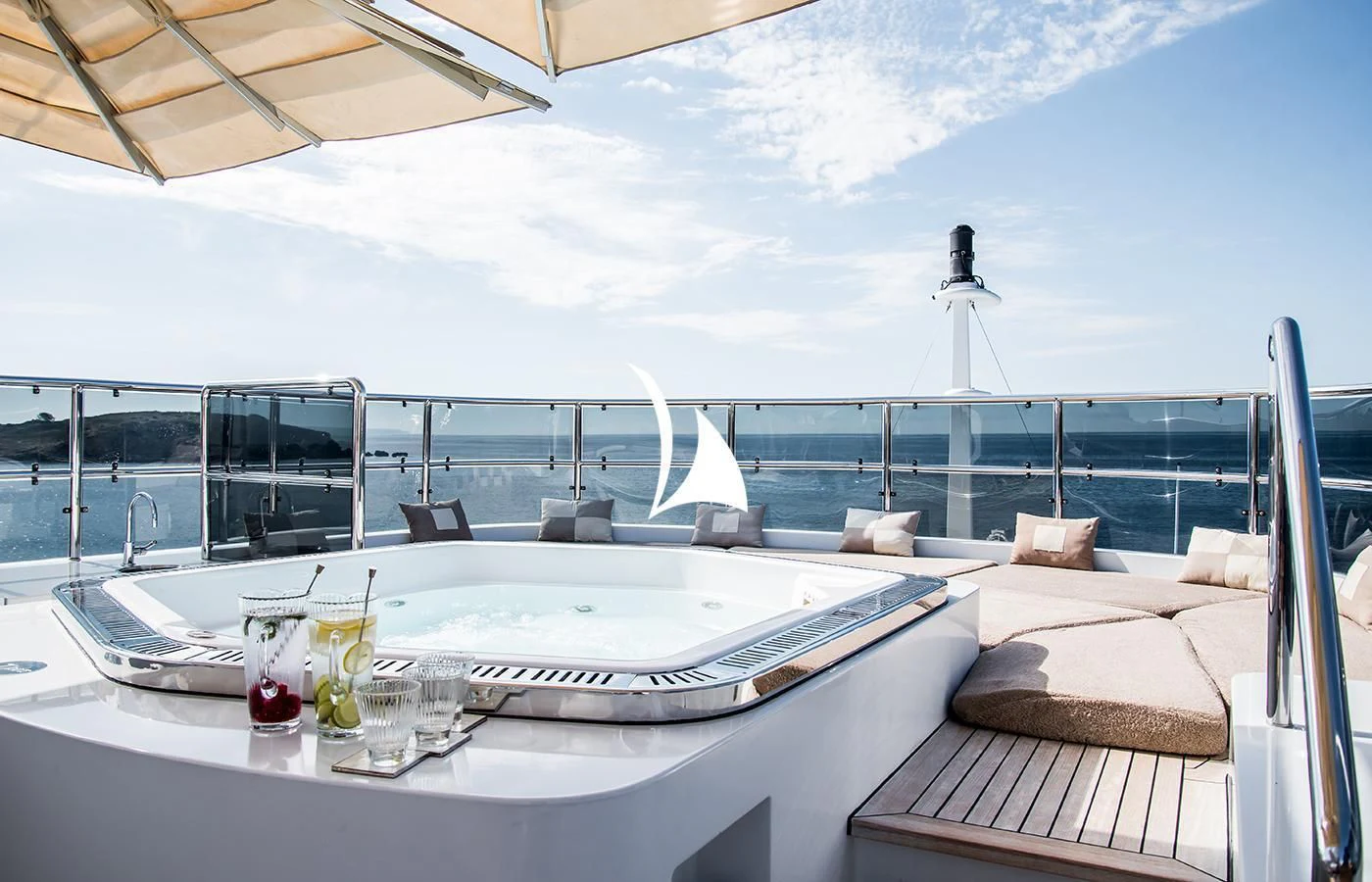 a table with chairs and a view of the ocean aboard DIANE Yacht for Charter