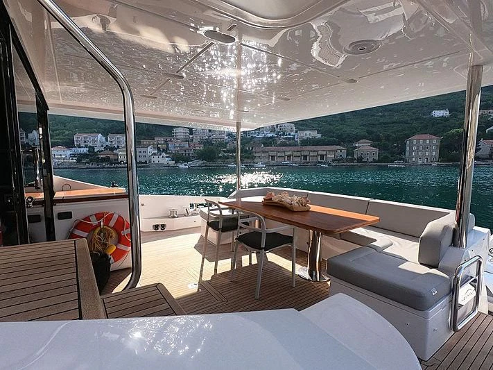 a room with a table and chairs aboard SOARING Yacht for Sale