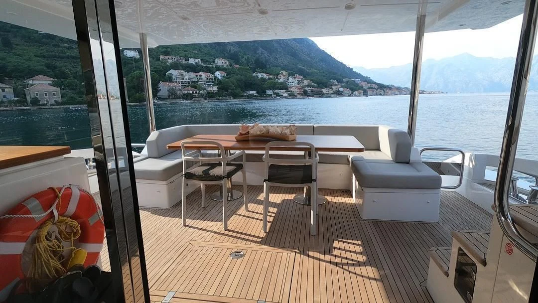 a room with a table and chairs aboard SOARING Yacht for Sale