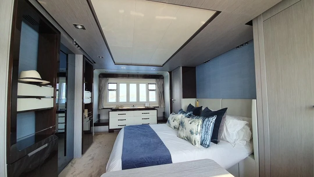a bedroom with a bed and a fireplace aboard SOARING Yacht for Sale