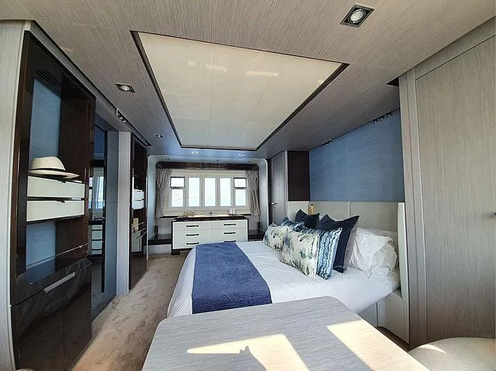 a bedroom with a bed and a desk aboard SOARING Yacht for Sale