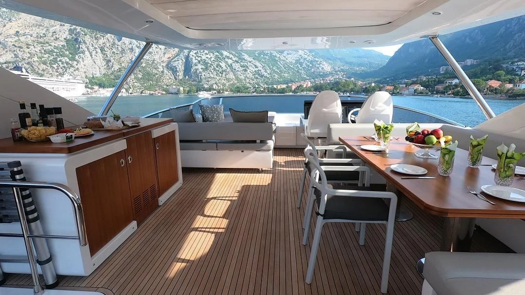 a room with a table chairs and a bed aboard SOARING Yacht for Sale
