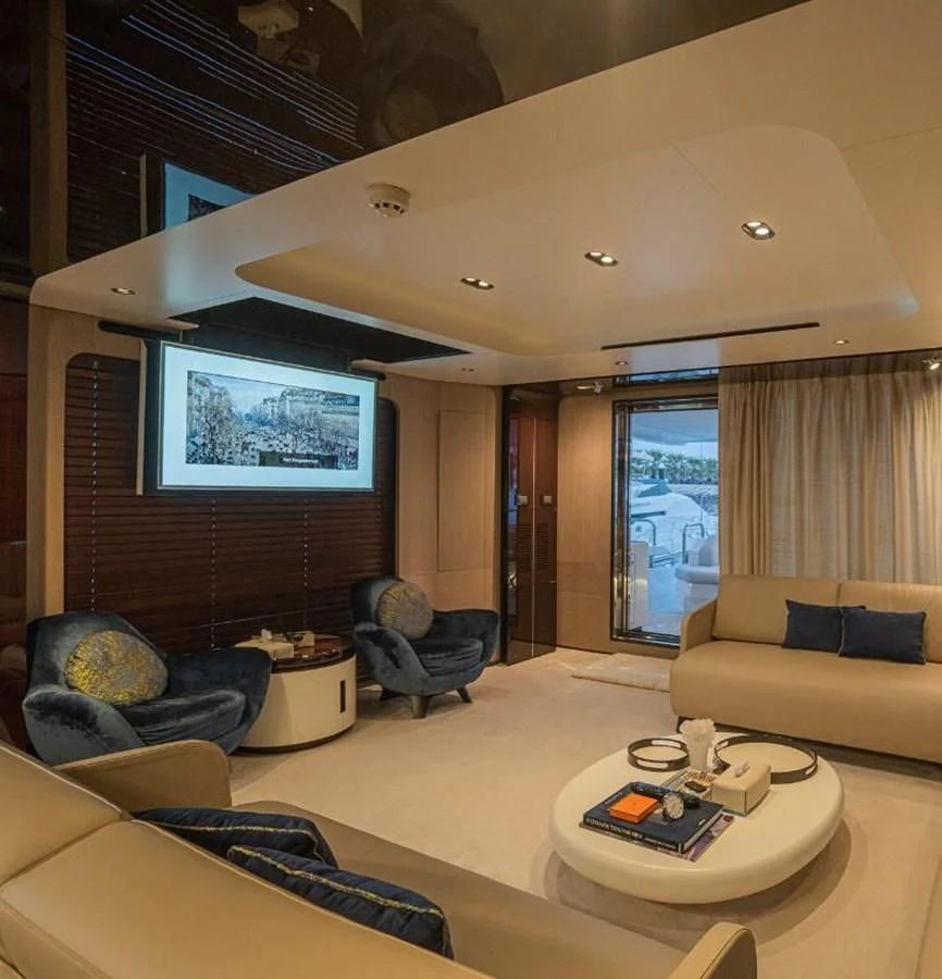 a living room with a large screen aboard LULWA Yacht for Sale