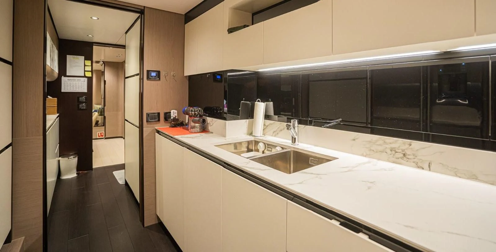 a large kitchen with white counter tops aboard LULWA Yacht for Sale
