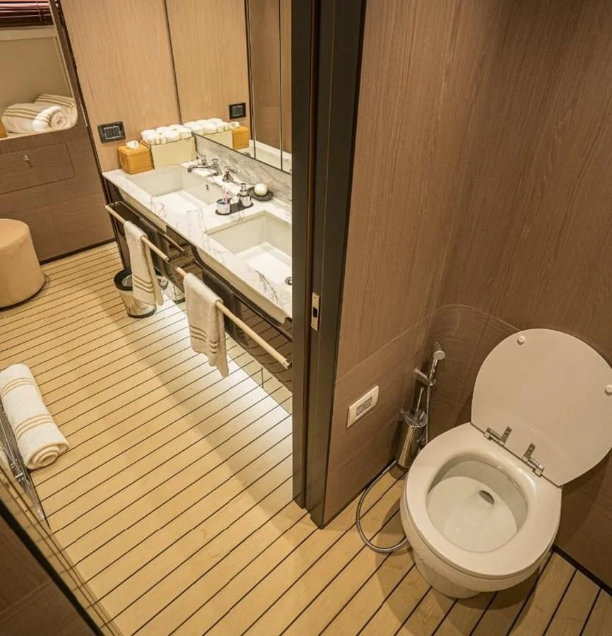 a bathroom with a toilet and sink aboard LULWA Yacht for Sale