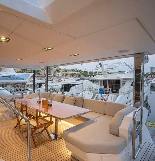 a table and chairs on a boat aboard LULWA Yacht for Sale