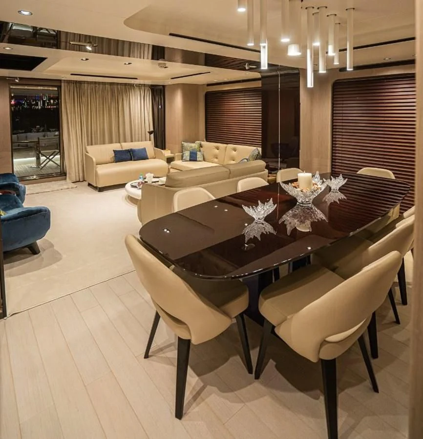 a large room with a table and chairs aboard LULWA Yacht for Sale