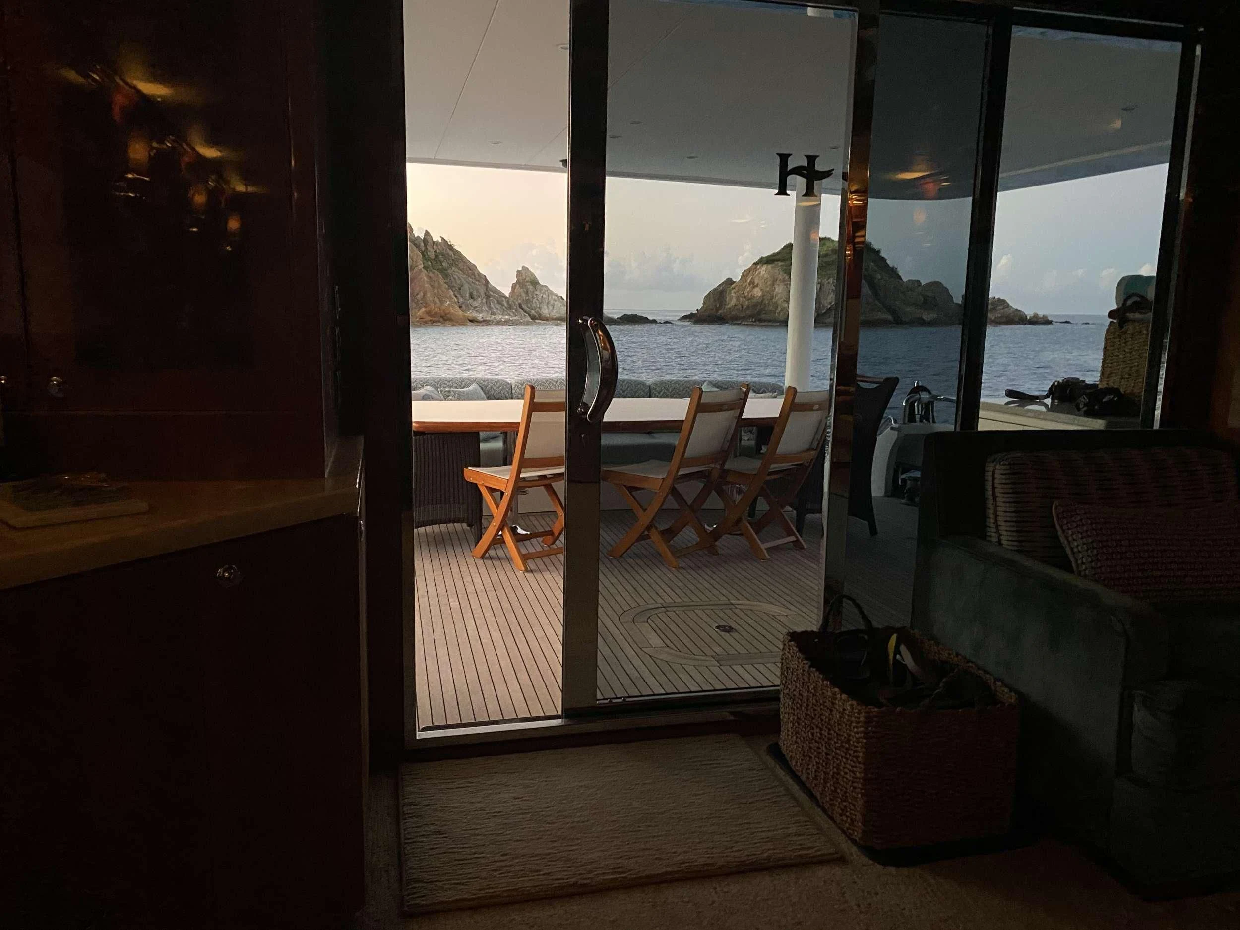 a room with a view of the ocean and mountains aboard CYNDERELLA Yacht for Sale