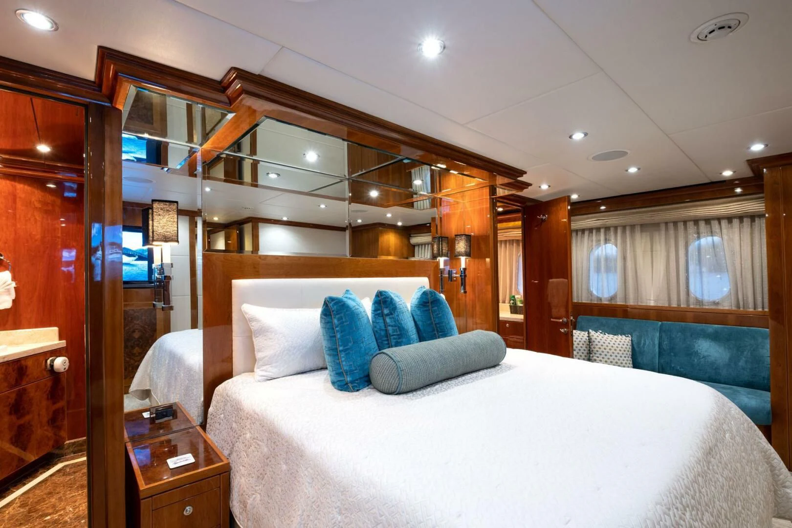 a bed with blue pillows aboard CYNDERELLA Yacht for Sale