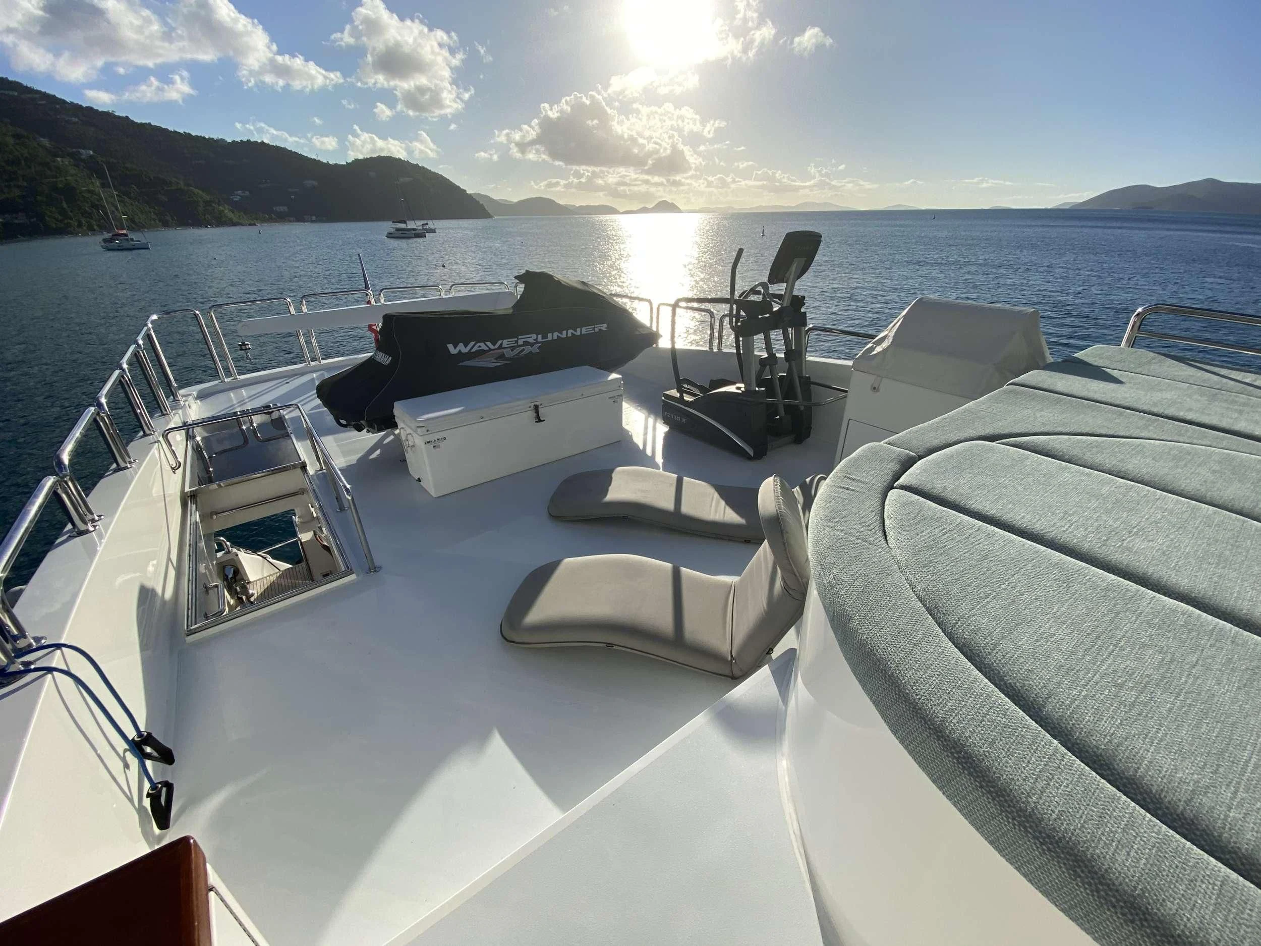 a boat with a deck and chairs on it aboard CYNDERELLA Yacht for Sale